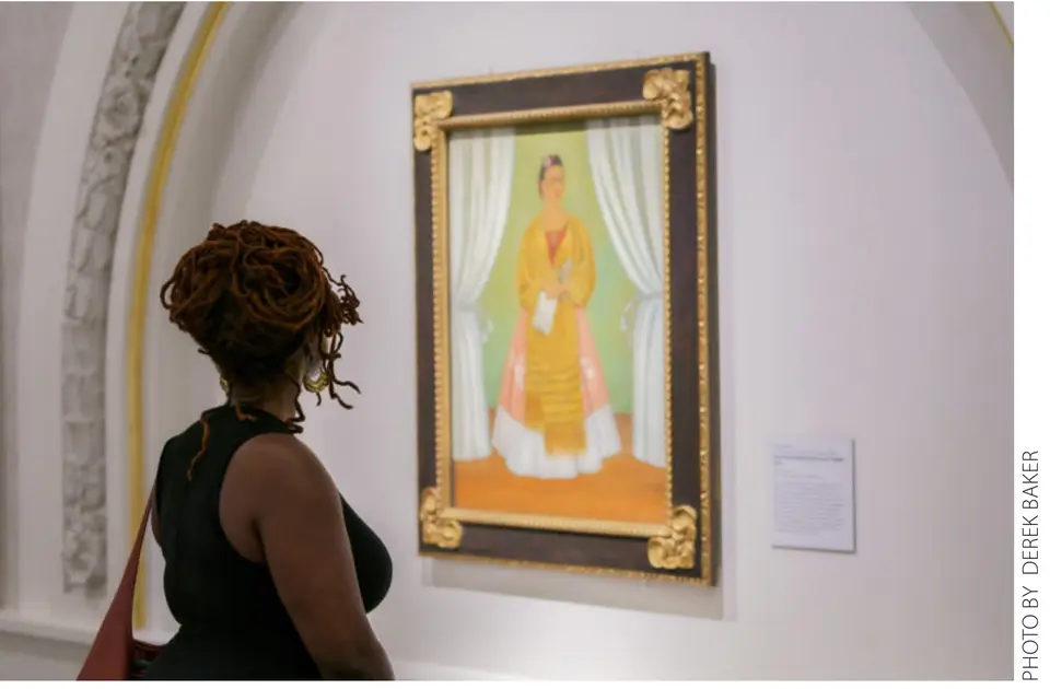 A visitor views Frida Kahlo's self-portrait at the National Museum of Women in the Arts. Photo by Derek Baker.