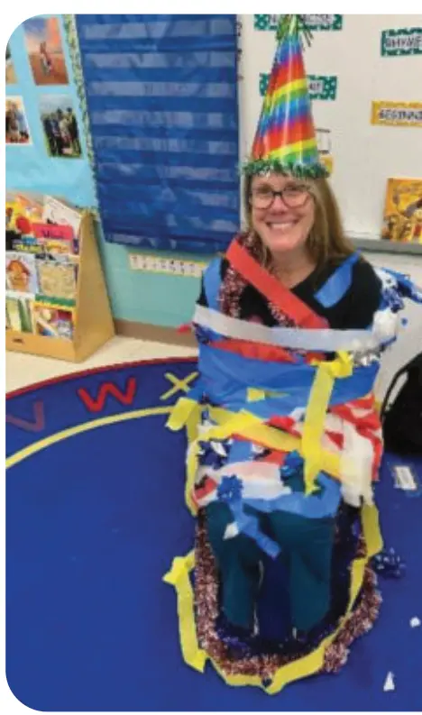 A pre-K class decorated the author as a holiday tree during a school-based activity.