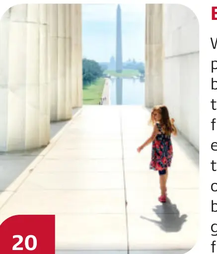 A child walks along the Lincoln Memorial colonnade with the Washington Monument in view.