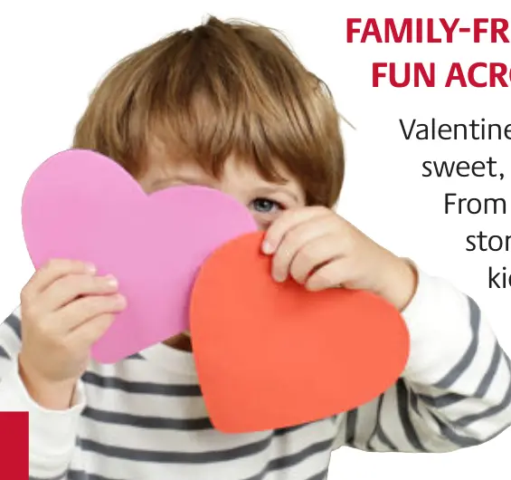 A child holds up paper hearts for Valentine's Day.