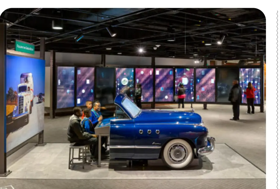 Visitors explore an interactive gallery featuring a vintage automobile. (Photo courtesy National Museum of African American History and Culture)