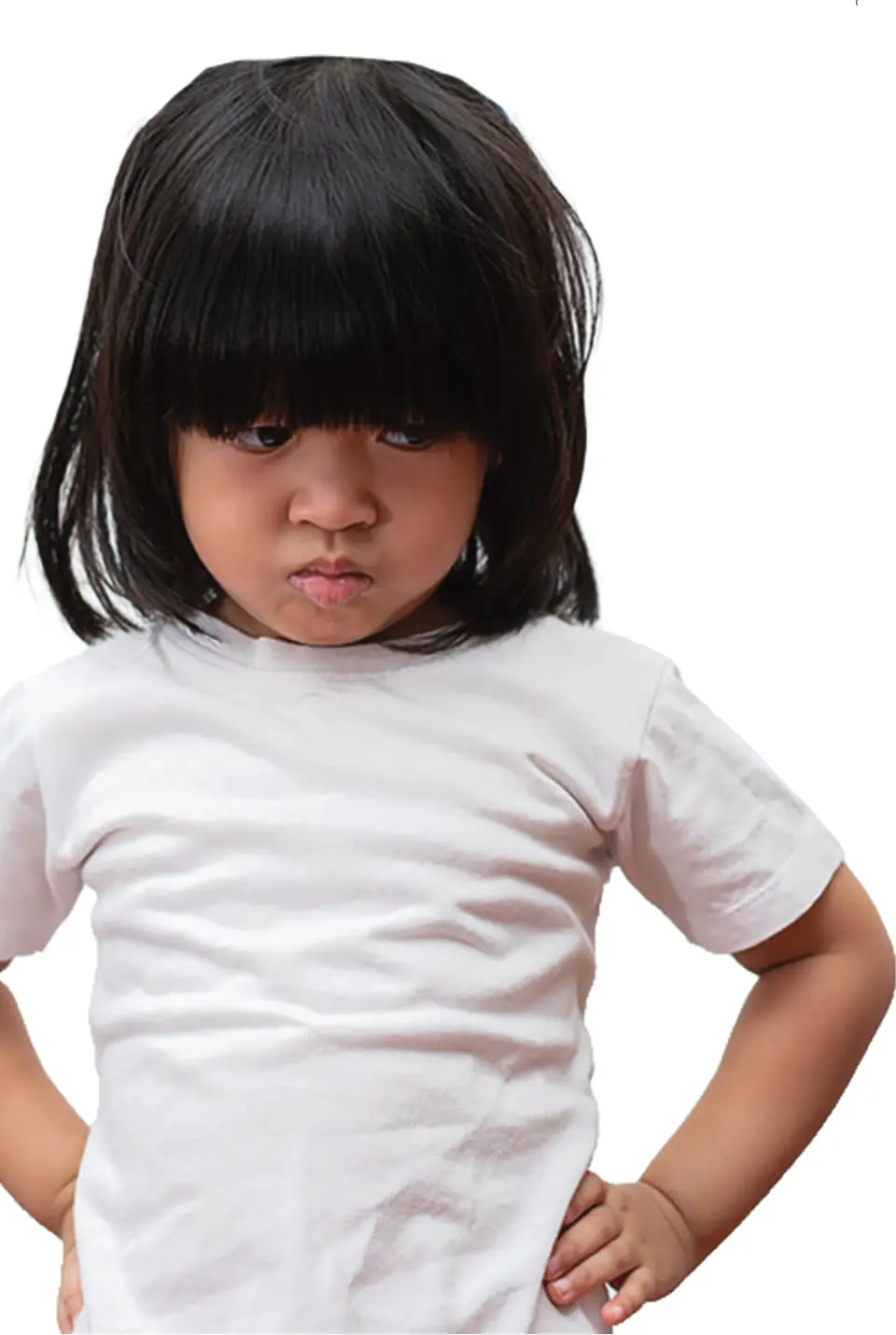 A young child stands with hands on hips, frowning. (Bigstock/Prot56)