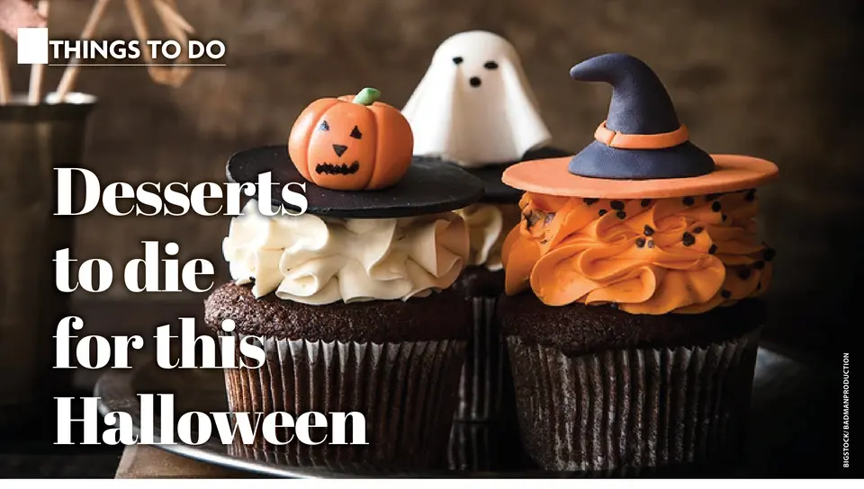 Halloween-decorated cupcakes with pumpkin, ghost and witch hat toppers. (Bigstock/Badmanproduction)