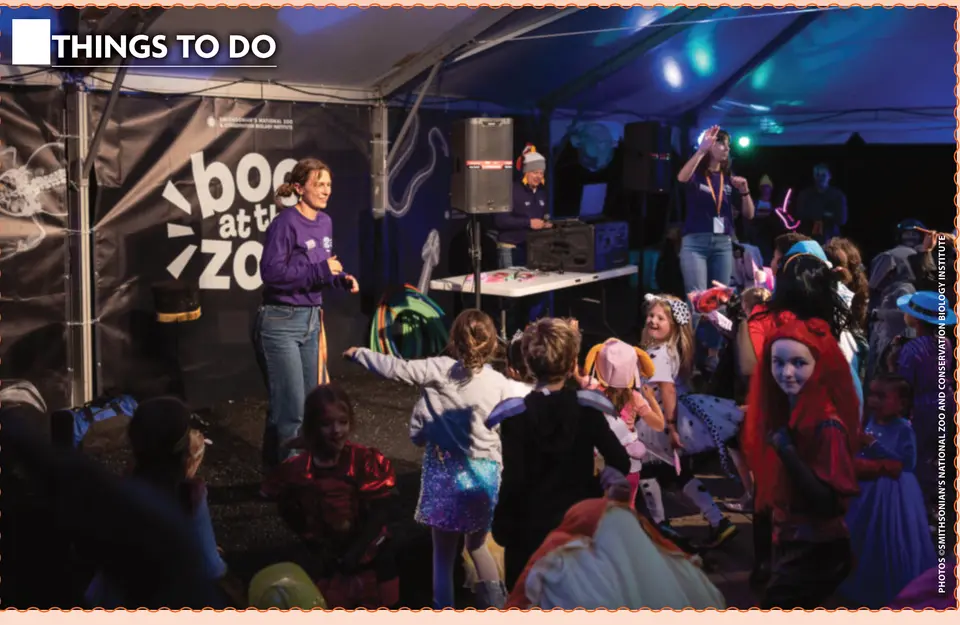 Costumed kids gather for a dance party under the Boo at the Zoo tent.